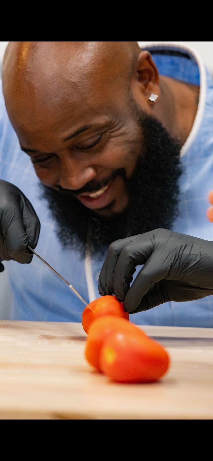 Chef Rudy Poindexter working with a knife