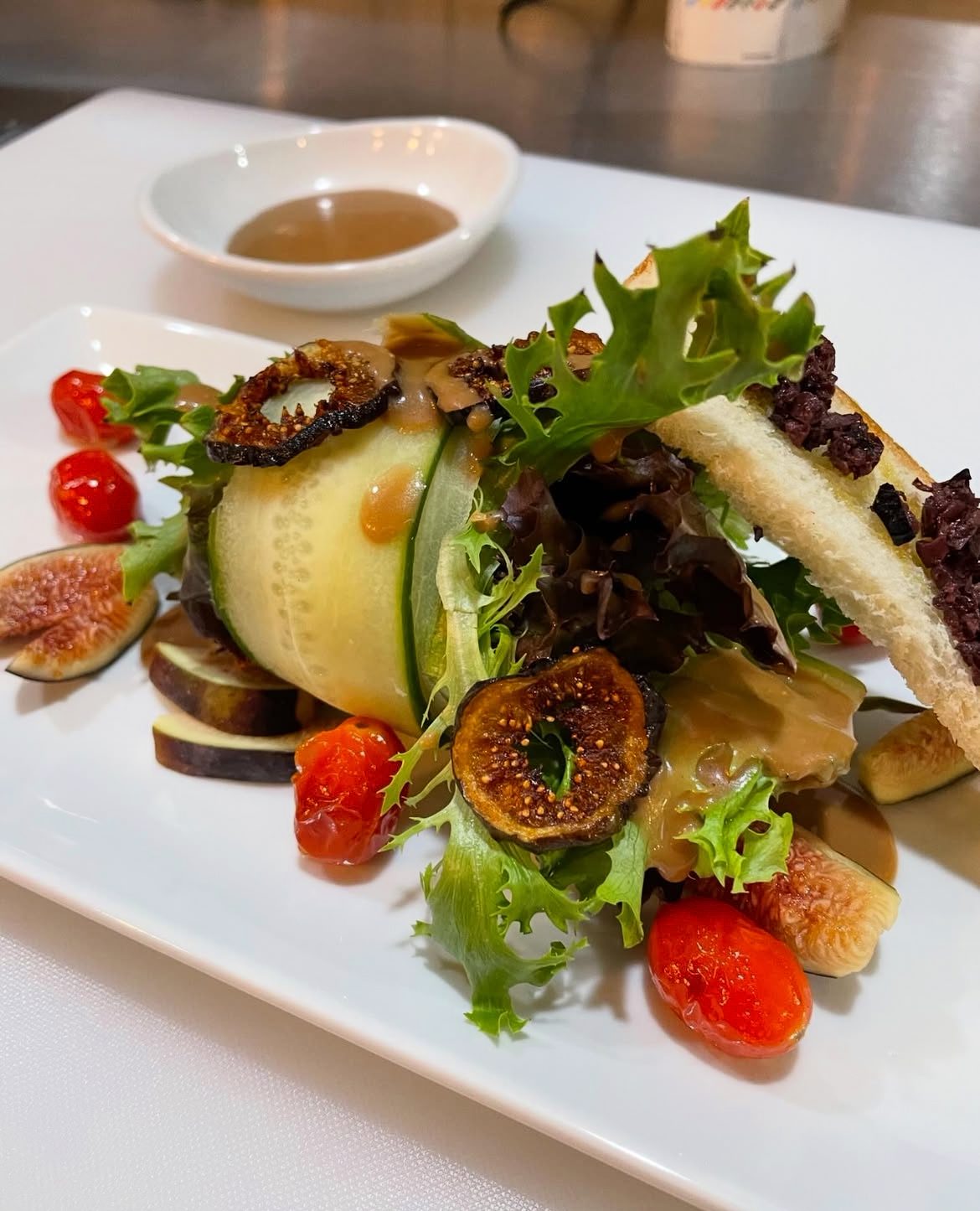 Fig, cucumber and olive toast plated for a villa table